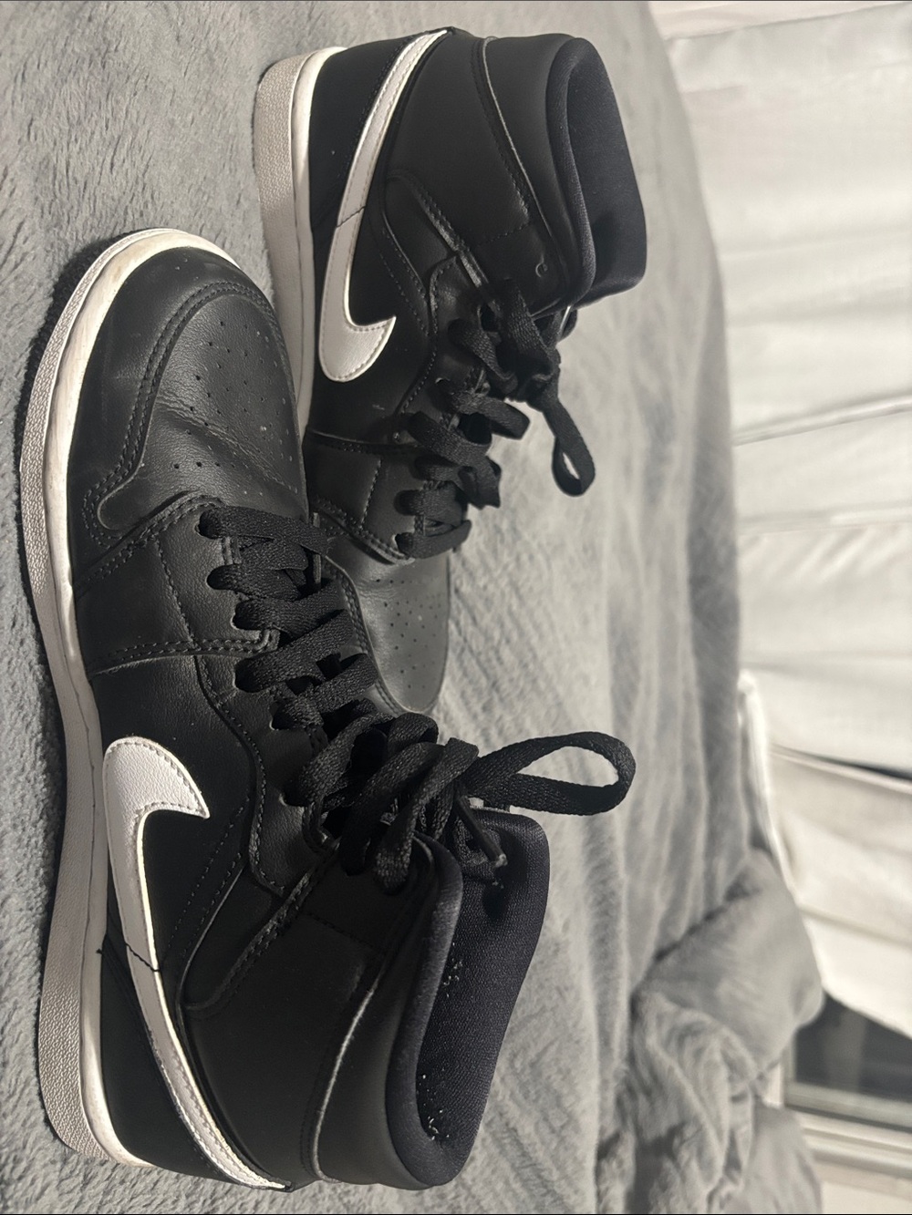 Nike Womenβs Black and White High-Top Sneakers with Swoosh